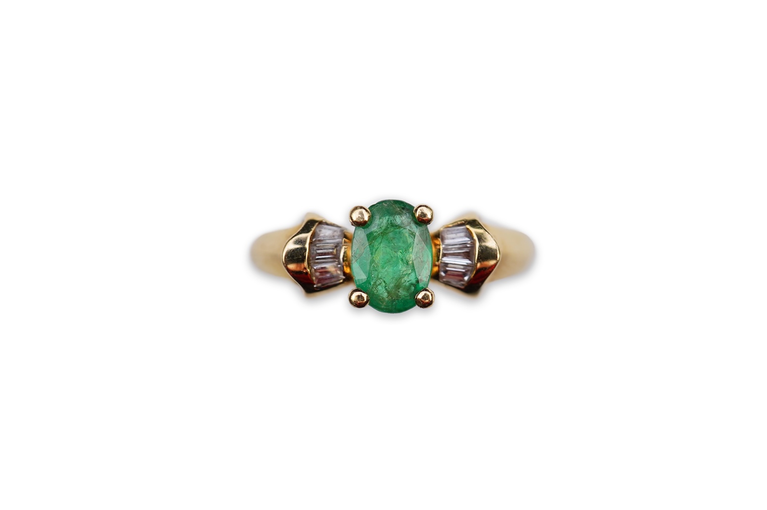 An emerald and diamond ring